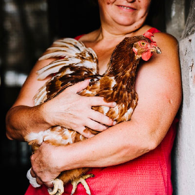 Homeowners holding pet bird after selling their property