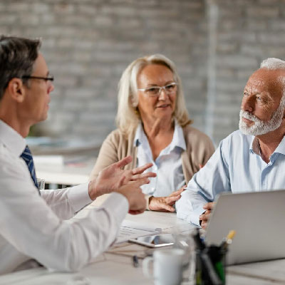 Homeowners at the closing table selling their property